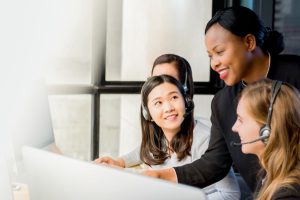 Friendly black businesswoman supervisor working with her team in call center